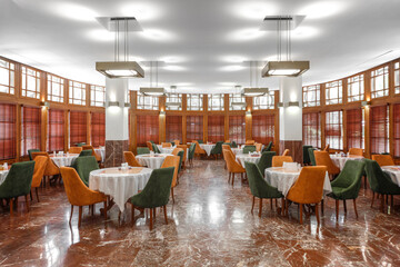 Restaurant in modern interior and round tables and brown wooden walls