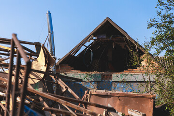 Fototapeta premium Destroyed residential private house due to explosion. The collapse of a brick house, the collapse of the walls