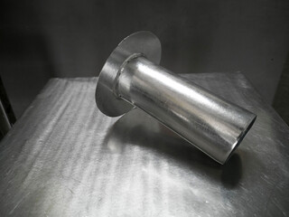 Downspout Funnel for Downpipe, Galvanized steel Funnel is put on the stainless table, photo is Depth of Field style
