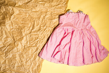 baby pink dress with space for text flat lay