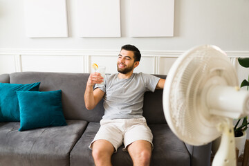 Smiling man enjoying a cold drink in the summer