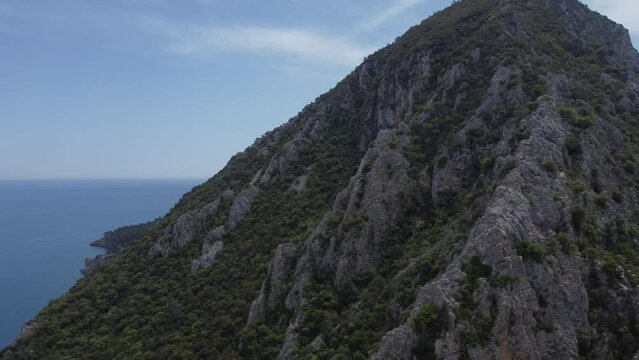 Sunny day, aerial view, flyby of points of interest, Mount Olympus, Olympus village, Turkey, Lycian Trail. Aerial drone of Cirali beach and Olympos Olimpos mountain in a beautiful day light. Kemer