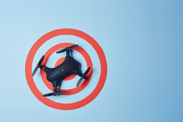 Aerial top down view on isolated drone copter landed in the center of reached red target on the...