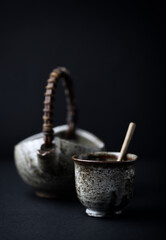 Traditional, handcrafted ceramic on dark background. Soft focus. Close up. Copy space.