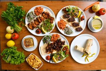 Delicious meat kebab with fresh vegetable salad served with variety of Turkish dishes and appetizers. Top view of assorted Turkish food and meze, tasty and healthy Mediterranean cuisine.