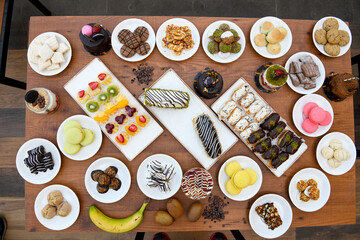 Fototapeta na wymiar Table scene of assorted take out or delivery foods. Traditional Turkish cuisine. Various Turkish desert and cake. Top down view on a table.