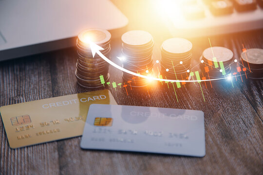 Credit bank card, money and coins on the home wood table, with selective focus, soft light and vintage filter, business concept