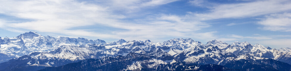 Panorama of Alps mountain peaks Eiger, Moench and Jungfrau in the bernese alps viewed from Niederhorn mountain, Switzerland