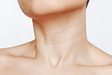 Сlose up of young woman's neck with lines isolated on a white background. Wrinkles, creases,...
