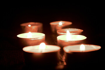 Burning candles on a black background in honor of the Commemoration.The concept of mourn, grief or...