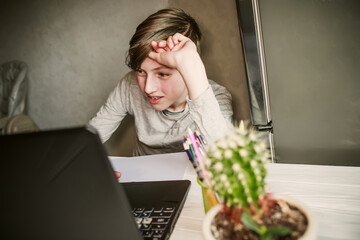 teenager working on a laptop computer at home Office concept. back to school