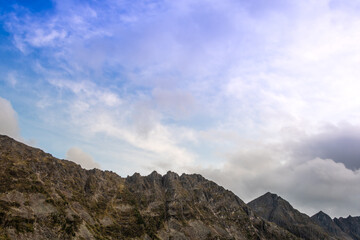 Alpine range on horizon. Structure of rocks with stones on slope. Silhouette of mountain line. Plan to reach top for relaxation, trail in highlands.