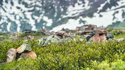 Stone pyramids of cobblestones on top of mountain under thick clouds overlooking valley. Landmark for navigating in fog in highlands. Meditation to strengthen strength of spirit.