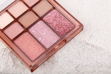 Mua and girly concept. Eyeshadow palette on concrete background  close up. Eye shadows cosmetics product as luxury beauty brand promotion. Contouring palette. Makeup palette.