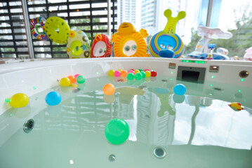Colorful inflatable balls on water and many rubber rings design for kid play