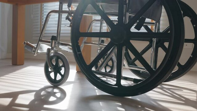 Empty Wheelchair in living room with warm sun light. Feeling Lonely, Sadness, hope concept.