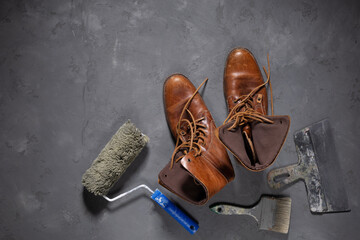 Worker boots and construction tools on cement floor. Tool construction concept