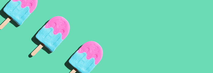 Pink and blue popsicles with shadow - flat lay