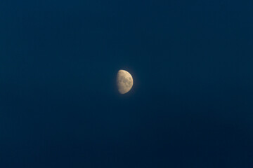 Close up of nice crescent moon on a dark blue sky. Stock photo of the details of the moon in the...