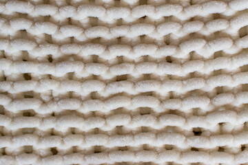 white knitting background featuring hand knit fabric in soft super chunky yarn 