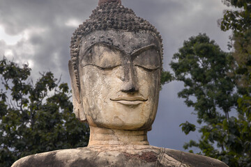 Fototapeta na wymiar Seated Buddha Face at Wat Phra Kaeo, Kamphaeng Phet, Thailand