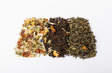 Herbal, black and green tea isolated on white background. Dry tea leaves in a pile on a white background.Tea platter.