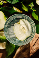 fresh apple drink: green leafs on wooden table