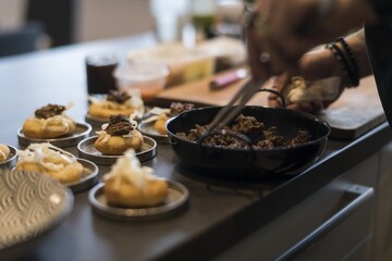 Preparing dinner. Boar, sea buckthorn, sauerkraut, crawfish, plate. Table, close-up, dining, background, lighting, people. Beautiful surroundings, adventure restaurant.