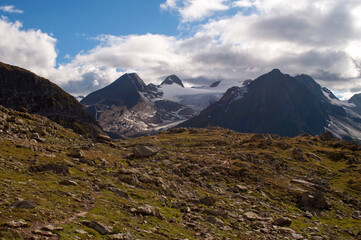 Panorama of high mountains with rocks and snowy peaks in the Swiss Alps.