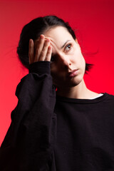 brunette woman in black clothes on red background. High quality photo
