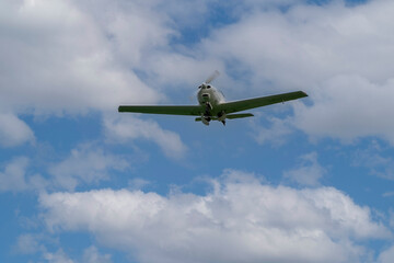 A small light plane on a background of the blue sky