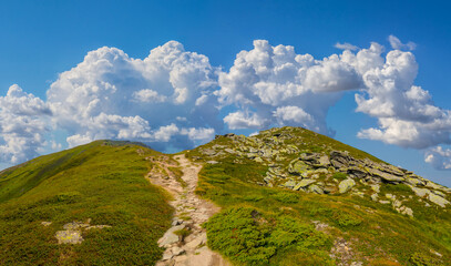 green mougreen mountain ridge with huge stones under cloudy skyntain ridge with huge stones under cloudy sky