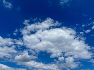 Blue sky with clouds. Bright sun in a blue sky. Sky with copyspace