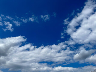 Blue sky with clouds. Bright sun in a blue sky. Sky with copyspace