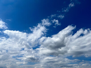 Naklejka na ściany i meble Blue sky with clouds. Bright sun in a blue sky. Sky with copyspace