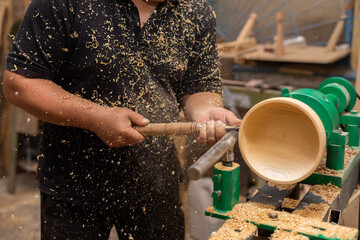 Carpenter turning wood on a lathe