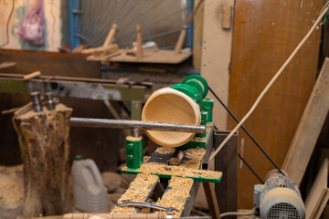 Lathe machine with wooden turning blanks in workshop