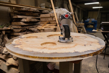 Wood router on a wooden table in workshop