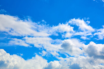 Naklejka na ściany i meble Blue sky with white cumulus clouds. Banner. Background. Nature wallpaper. Sunny weather forecast. Religion concept. Heaven landscape. Outdoor scenic. Bright pattern design. Copy space. Fresh air