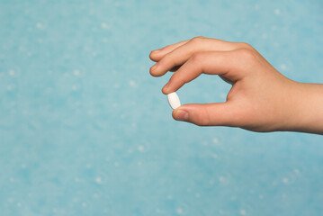 Close-up of a pill in a doctor's hand