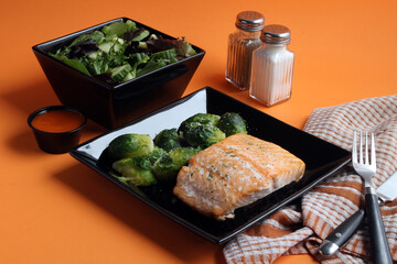 Salmon Steak with Brussels sprouts and salad.