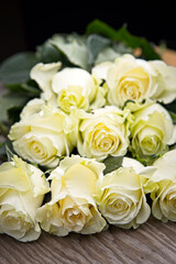 Obraz premium Roses stacked up on a table.