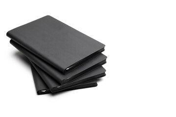 Stack of black blank notebook isolated on isolated white background. Mock up for branding.