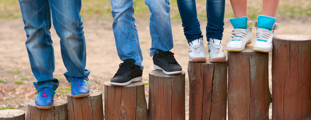 Legs and sneakers of teenage boys and girls