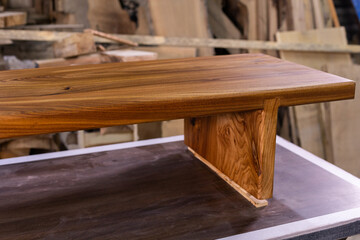 Newly-made brown wooden table in the workshop