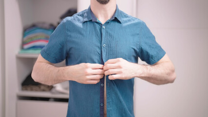 Headless male person button up elegant blue shirt with short sleeves