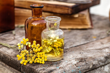 july arenarium in a spoon, helichrysum arenarium, dwarf everlast, immortelle, curry plant, italian strawflower apothecary bottles