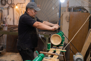 Carpenter preparing machine for turning wood on a lathe