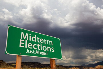 Midterm Elections Green Road Sign Over Dramatic Clouds and Sky.