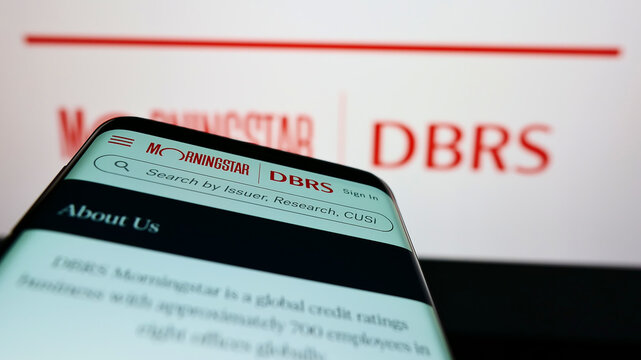Stuttgart, Germany - 03-06-2022: Mobile phone with webpage of Canadian credit rating company DBRS Morningstar on screen in front of logo. Focus on top-left of phone display.
